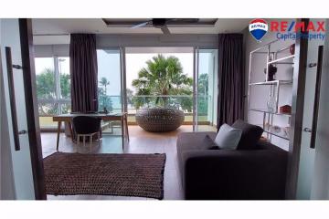 Cozy living room with ocean view and balcony access