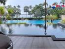 Tranquil outdoor swimming pool area with lush greenery and wooden deck