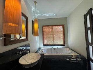 Modern bathroom with spa bathtub and stylish lighting fixtures