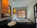 Modern bathroom with spa bathtub and stylish lighting fixtures