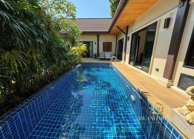 Private swimming pool with tropical garden in a residential villa