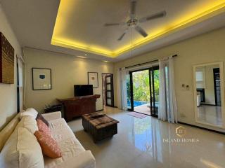 Spacious living room with modern furniture and ample lighting