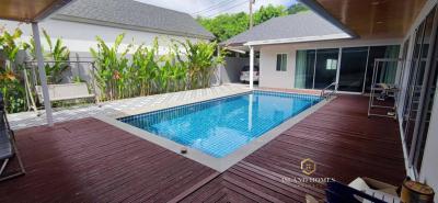 Spacious backyard with a swimming pool and wooden deck