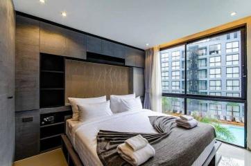 Modern bedroom interior with large window overlooking the pool