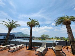 Spacious rooftop terrace with sun loungers and panoramic mountain views