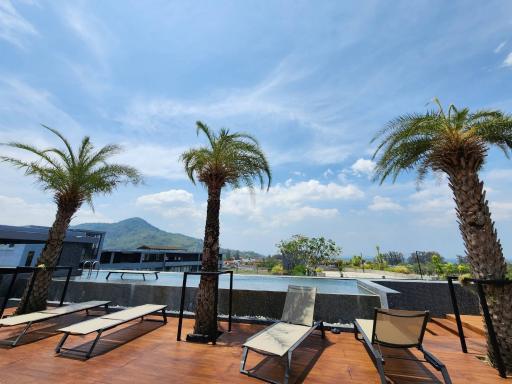 Spacious rooftop terrace with sun loungers and panoramic mountain views