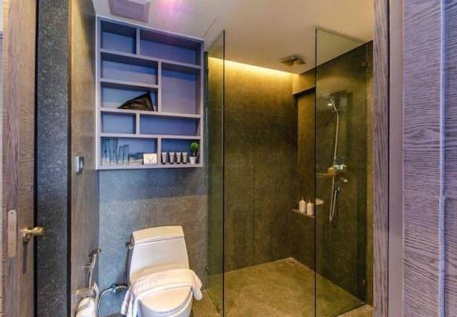 Modern bathroom with walk-in shower and built-in shelves