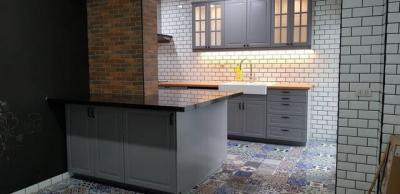 Modern kitchen with brick and tile walls and patterned tile flooring