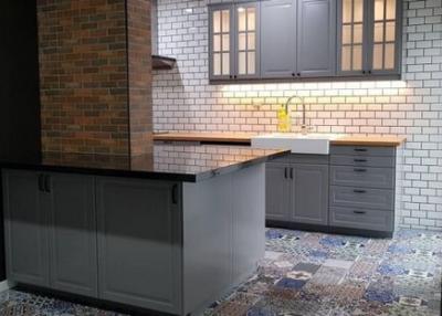 Modern kitchen with brick and tile walls and patterned tile flooring