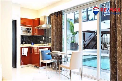 Modern kitchen with dining area and view of the pool