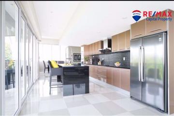 Modern kitchen with stainless steel appliances and breakfast bar