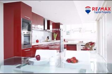 Modern kitchen with red cabinets and white interiors