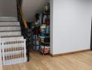 Modern staircase area with wooden floors and storage shelves