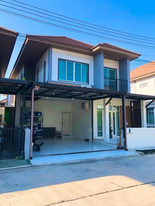 Contemporary two-story house with carport and balcony