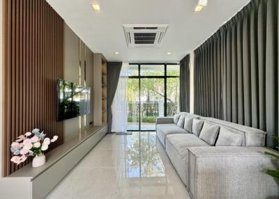 Modern living room with large sofa and flat-screen TV