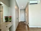 Bright and modern hallway with wooden flooring and built-in storage