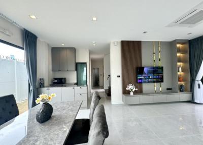 Modern open concept living room with kitchen in the background