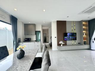 Modern open concept living room with kitchen in the background