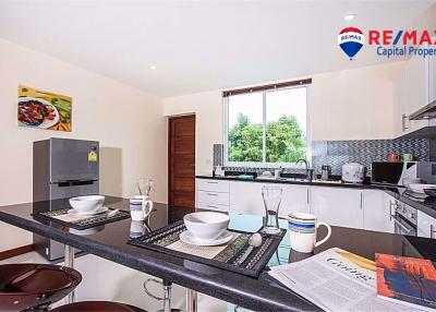 Modern kitchen with stainless steel appliances and breakfast bar