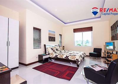 Spacious bedroom with modern furniture and ample lighting