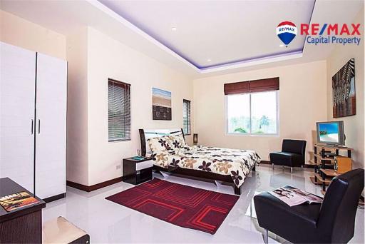 Spacious bedroom with modern furniture and ample lighting