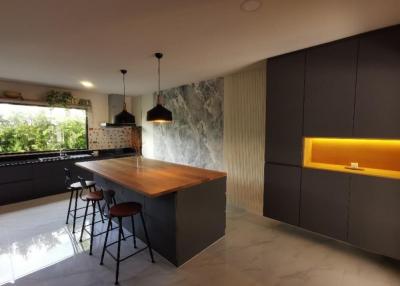 Modern kitchen with dark cabinetry and central island