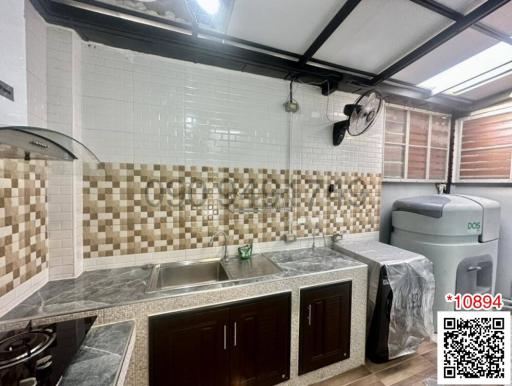 Modern kitchen with stainless steel appliances and mosaic backsplash