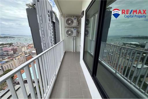 Spacious balcony with ocean view and air conditioning units