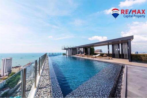 Rooftop infinity pool with ocean view and lounge area