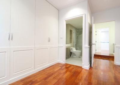 Spacious hallway with hardwood floors and access to bathroom