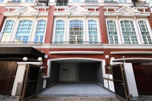 Elegant red-brick building facade with parking entrance