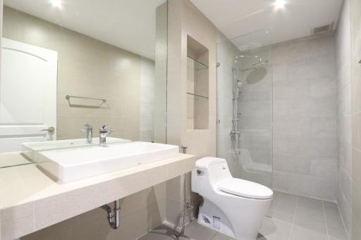 Modern bathroom with large mirror and walk-in shower