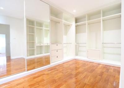 Spacious bedroom with large built-in closets and hardwood floors