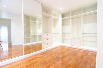 Spacious bedroom with large built-in closets and hardwood floors