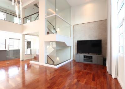 Spacious modern living room with high ceilings and hardwood floors