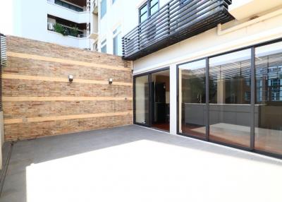 Spacious and modern patio with glass doors and brick walls
