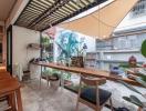 Modern patio area with wooden dining table and artistic wall mural