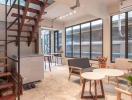 Modern living room with staircase and expansive windows