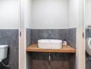 Compact modern bathroom with grey tiling