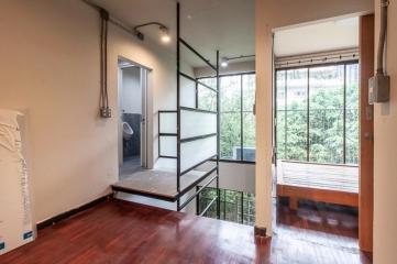 Cozy bedroom with large windows and a balcony