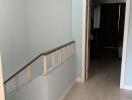 Spacious hallway with wooden flooring leading to the rooms