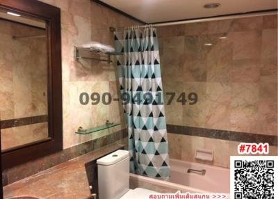 Marble tiled bathroom with bathtub and modern amenities