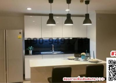 Modern kitchen with black countertops and pendant lighting