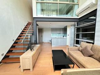 Modern living room with open kitchen and staircase