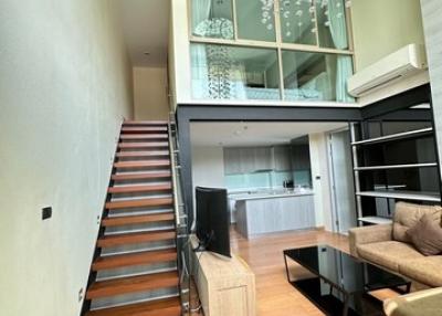 Contemporary living room with mezzanine and open-concept kitchen