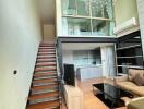 Contemporary living room with mezzanine and open-concept kitchen