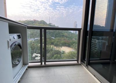 Spacious balcony with washing machine and scenic view