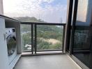 Spacious balcony with washing machine and scenic view