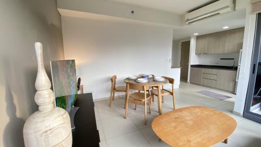 Bright and modern open space living area with dining set and adjoining kitchen
