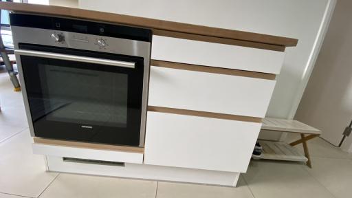 Modern kitchen with built-in oven and sleek white cabinet design